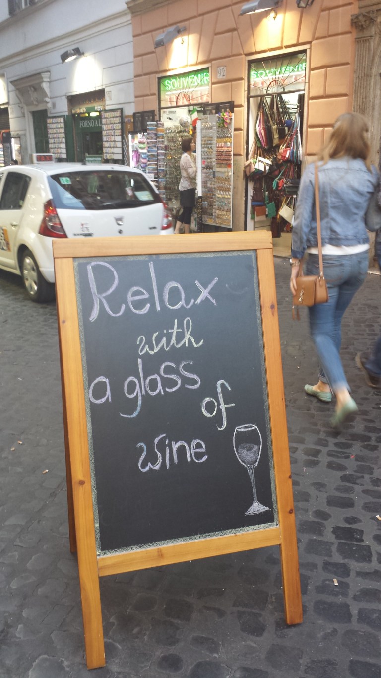 relax with a glass of wine sign in Rome