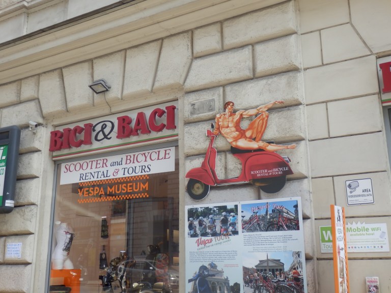 Sign with naked Adam sitting on a scooter in Rome