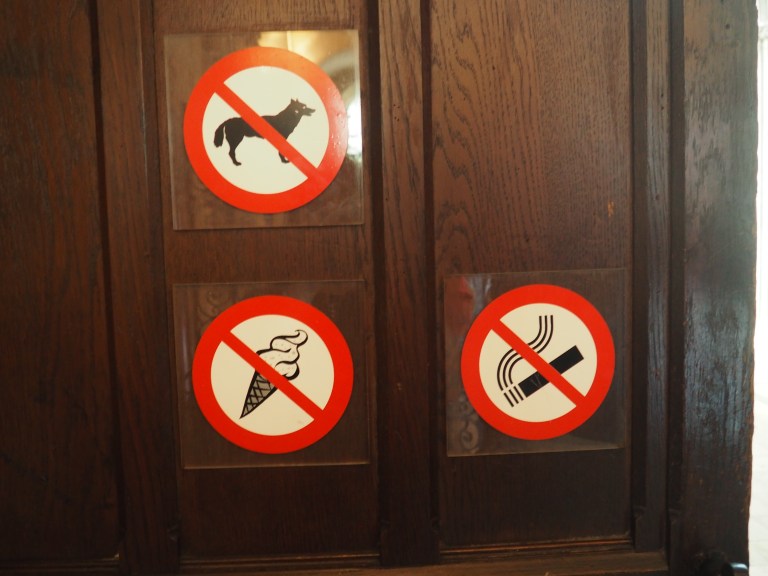 Bayeux Cathedral no dogs food cigarettes sign on door